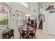 Cozy dining area with a round wooden table, seating for four, and natural light filtering through the window at 19624 Spring Oak Dr, Eustis, FL 32736