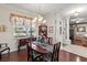 Elegant dining room featuring hardwood floors, chandelier, and china cabinet, with an entryway to the living room at 19624 Spring Oak Dr, Eustis, FL 32736