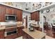 Charming kitchen featuring granite countertops, dark wood cabinets, and stainless steel appliances at 19624 Spring Oak Dr, Eustis, FL 32736