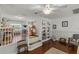 Charming living area featuring hardwood floors, built-in shelving, and a cozy step-up area at 19624 Spring Oak Dr, Eustis, FL 32736