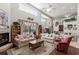 Spacious living room featuring a fireplace, comfortable sofas, and access to a backyard pool through sliding glass doors at 19624 Spring Oak Dr, Eustis, FL 32736