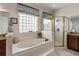 Spa-like main bathroom featuring a soaking tub with tile surround and a separate glass shower at 19624 Spring Oak Dr, Eustis, FL 32736