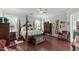 Elegant main bedroom featuring hardwood floors, a four-poster bed, and decorative furnishings at 19624 Spring Oak Dr, Eustis, FL 32736