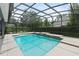 Sparkling screened-in pool with waterfall features in the backyard at 19624 Spring Oak Dr, Eustis, FL 32736