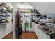 Organized walk-in closet features white wire shelving and hardwood floors at 19624 Spring Oak Dr, Eustis, FL 32736