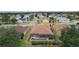Backyard pool, screened-in lanai, well-maintained lawn, and neatly trimmed shrubs in quiet residential area at 1972 Palo Alto Ave, The Villages, FL 32159