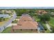 Home with private pool, screened-in patio, lush landscaping, and brick driveway in quiet residential neighborhood at 1972 Palo Alto Ave, The Villages, FL 32159