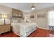 Relaxing bedroom with hardwood floors, large bed, ceiling fan and ample natural light at 1972 Palo Alto Ave, The Villages, FL 32159