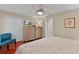 Comfortable bedroom with wood floors, television, ceiling fan and double closets at 1972 Palo Alto Ave, The Villages, FL 32159