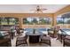 A large covered patio has elegant outdoor furniture and views of the beautiful sparkling pool and spa at 1972 Palo Alto Ave, The Villages, FL 32159