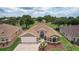 Charming single-story home with a brick driveway, well-manicured lawn, and mature landscaping at 1972 Palo Alto Ave, The Villages, FL 32159