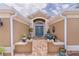 Inviting front entrance with a blue glass door, brick pavers and manicured landscaping at 1972 Palo Alto Ave, The Villages, FL 32159