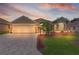 Charming single-story home boasts a well-manicured lawn, brick driveway, and attached two-car garage at 1972 Palo Alto Ave, The Villages, FL 32159