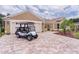 Lovely home with brick driveway, two-car garage and an inviting front porch and convenient golf cart at 1972 Palo Alto Ave, The Villages, FL 32159