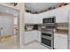 Well-equipped kitchen featuring stainless steel appliances, tile backsplash, and ample cabinet space at 1972 Palo Alto Ave, The Villages, FL 32159