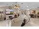 Living room showcasing an open layout, comfortable seating, and a view into the dining area at 1972 Palo Alto Ave, The Villages, FL 32159