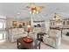 Open concept living area with view of kitchen, and comfortable seating arrangement with a decorative ceiling fan at 1972 Palo Alto Ave, The Villages, FL 32159
