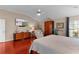 Relaxing main bedroom with beautiful hard wood floors, large dresser and television at 1972 Palo Alto Ave, The Villages, FL 32159