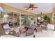 Covered patio with plenty of seating, a ceiling fan, and sliding glass doors creating an outdoor living space at 1972 Palo Alto Ave, The Villages, FL 32159