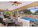 Screened patio with comfortable seating, ceiling fans, and a pool for entertaining or relaxing at 1972 Palo Alto Ave, The Villages, FL 32159