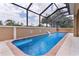 Private screened pool featuring a waterfall for a backyard oasis at 1972 Palo Alto Ave, The Villages, FL 32159