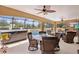Outdoor living space features a pool, covered patio, ceiling fan, and comfortable seating for relaxation at 1972 Palo Alto Ave, The Villages, FL 32159