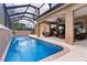 Sparkling screened pool with a waterfall feature and outdoor seating at 1972 Palo Alto Ave, The Villages, FL 32159