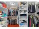Spacious walk-in closet with custom shelves, wood floors and ample room for storage at 1972 Palo Alto Ave, The Villages, FL 32159