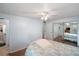Well-lit bedroom with wood floors, a comfortable bed, and a mirrored closet at 2110 Oak Cir, Mount Dora, FL 32757