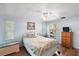 Cozy bedroom with wood floors, comfortable bed, dresser, and natural light at 2110 Oak Cir, Mount Dora, FL 32757