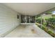 Spacious carport area, perfect for parking or outdoor seating, leading to a screened-in porch at 2110 Oak Cir, Mount Dora, FL 32757