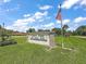 Dora Pines 55+ resident-owned community sign with an American flag waving in the breeze at 2110 Oak Cir, Mount Dora, FL 32757