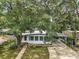 Charming home featuring a covered carport, quaint front yard, and mature shade trees at 2110 Oak Cir, Mount Dora, FL 32757