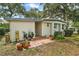 Charming home exterior with potted plants, a brick walkway, and blue trim accents at 2110 Oak Cir, Mount Dora, FL 32757
