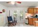 Bright kitchen with tiled floors, oak cabinets, and a view to the outdoor patio through glass doors at 2110 Oak Cir, Mount Dora, FL 32757
