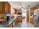 Traditional kitchen featuring tile flooring, wooden cabinets, and stainless steel appliances at 2110 Oak Cir, Mount Dora, FL 32757