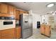 Spacious kitchen with stainless steel refrigerator and complementary wooden cabinets at 2110 Oak Cir, Mount Dora, FL 32757
