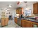 Bright kitchen with wooden cabinets, a window view, and stainless steel dishwasher at 2110 Oak Cir, Mount Dora, FL 32757