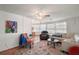 Spacious living room with comfortable seating, wood-look floors, and a view into the dining area at 2110 Oak Cir, Mount Dora, FL 32757