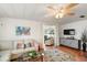 Comfortable living room with stylish decor, wood-look floors, and an open view to the sunroom at 2110 Oak Cir, Mount Dora, FL 32757