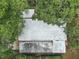 Aerial shot showcasing the roof of a house surrounded by lush greenery and treetops at 2110 Oak Cir, Mount Dora, FL 32757