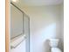 Bathroom featuring a glass shower enclosure and toilet, designed for functionality at 2120 Willow Grove Way, The Villages, FL 32162