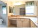 Bathroom featuring double sinks, a vanity area, and a separate shower stall at 2120 Willow Grove Way, The Villages, FL 32162