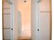Hallway featuring two closets equipped with ample shelving for storage at 2120 Willow Grove Way, The Villages, FL 32162