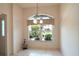Bright dining area with a large window, tile floors, and a chandelier providing a comfortable dining space at 2120 Willow Grove Way, The Villages, FL 32162