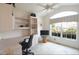 Bright home office with built-in shelving, a comfortable desk, and a large window offering a pleasant view at 2120 Willow Grove Way, The Villages, FL 32162