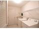Laundry room equipped with a washer, dryer, sink, and overhead storage shelf at 2120 Willow Grove Way, The Villages, FL 32162