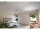Bedroom featuring two large windows and a plush chair for relaxation at 2120 Willow Grove Way, The Villages, FL 32162