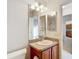 Bathroom vanity with a sink, well-lit mirror, and tiled floors, creating a functional and stylish space at 2202 Kershaw Rd, The Villages, FL 32162