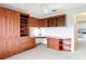 Bedroom with wood cabinets and a built-in desk illuminated by a ceiling fan, offering a functional and stylish space at 2202 Kershaw Rd, The Villages, FL 32162